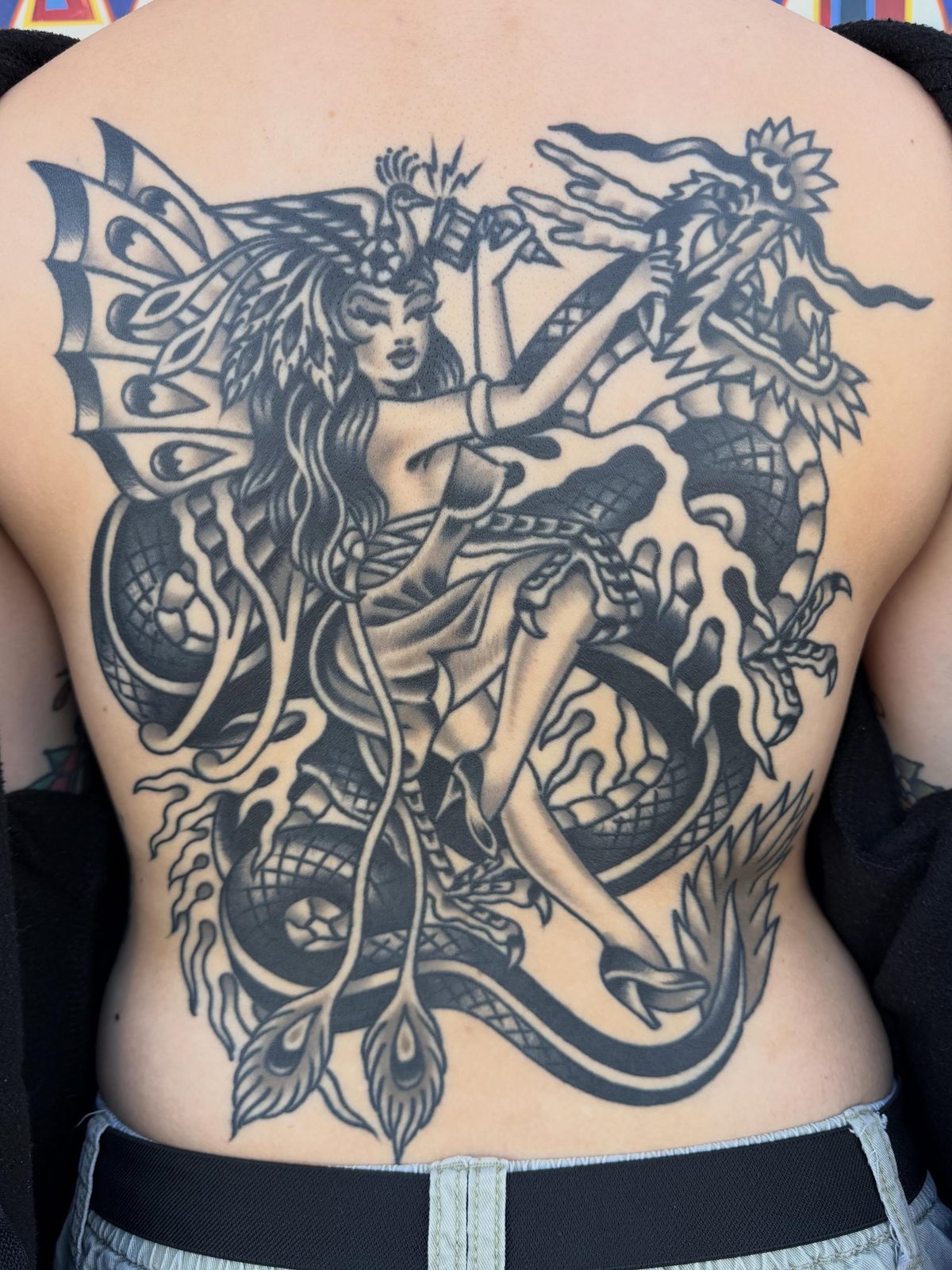 Large black and gray fantasy tattoo showing the dense detail possible in a cover-up design