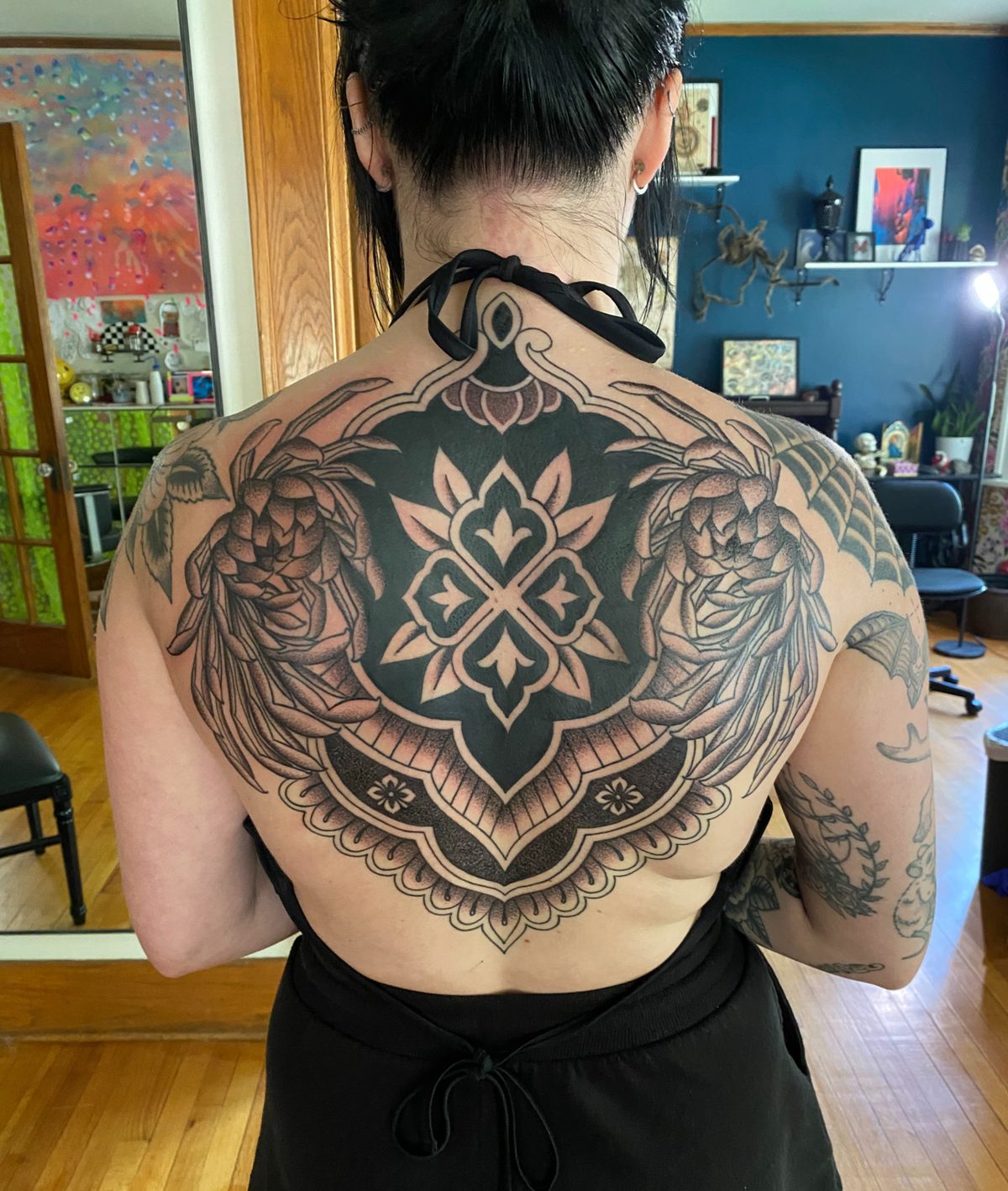 Detailed custom black and gray full-back tattoo composition