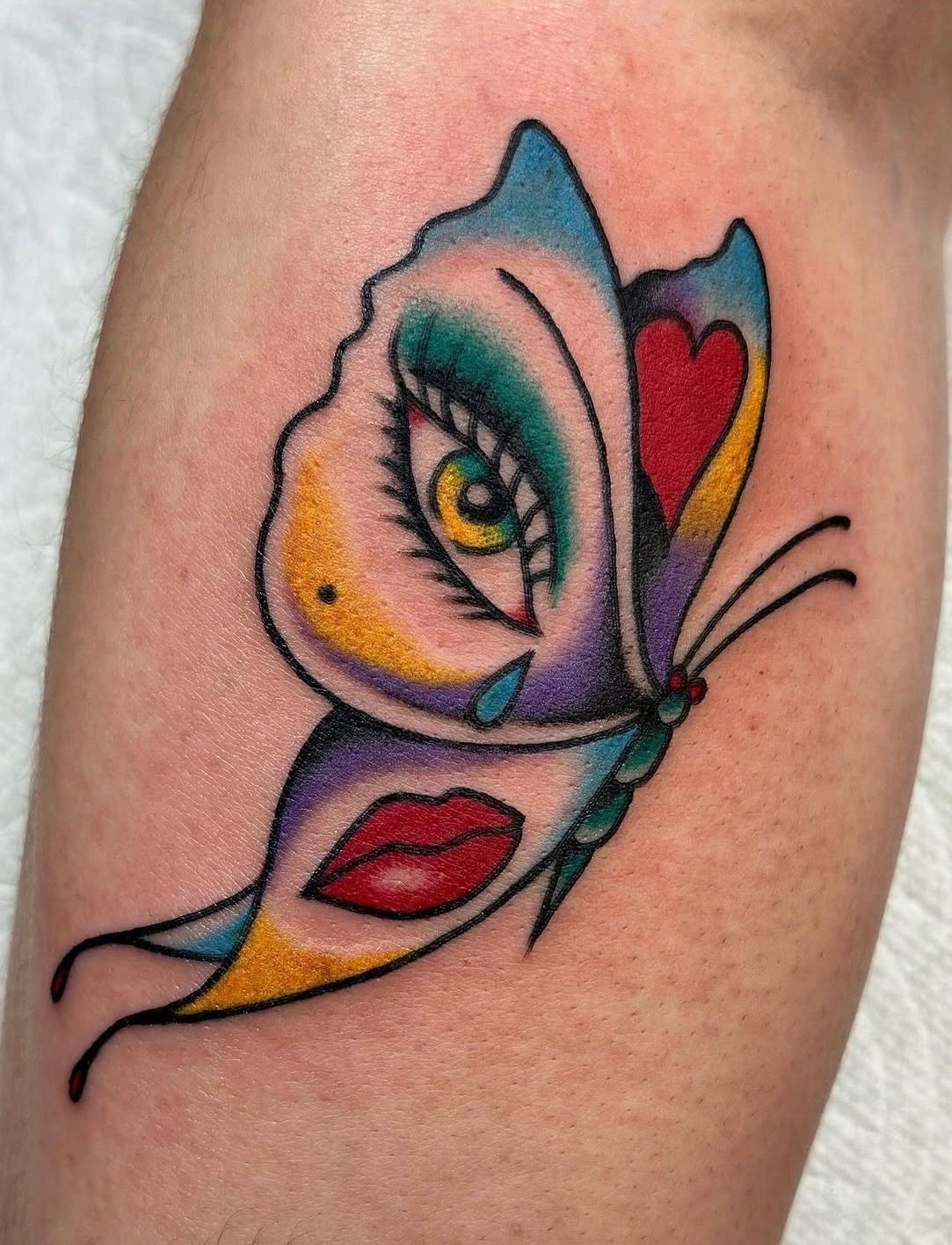 Color butterfly face tattoo with saturated illustrative details
