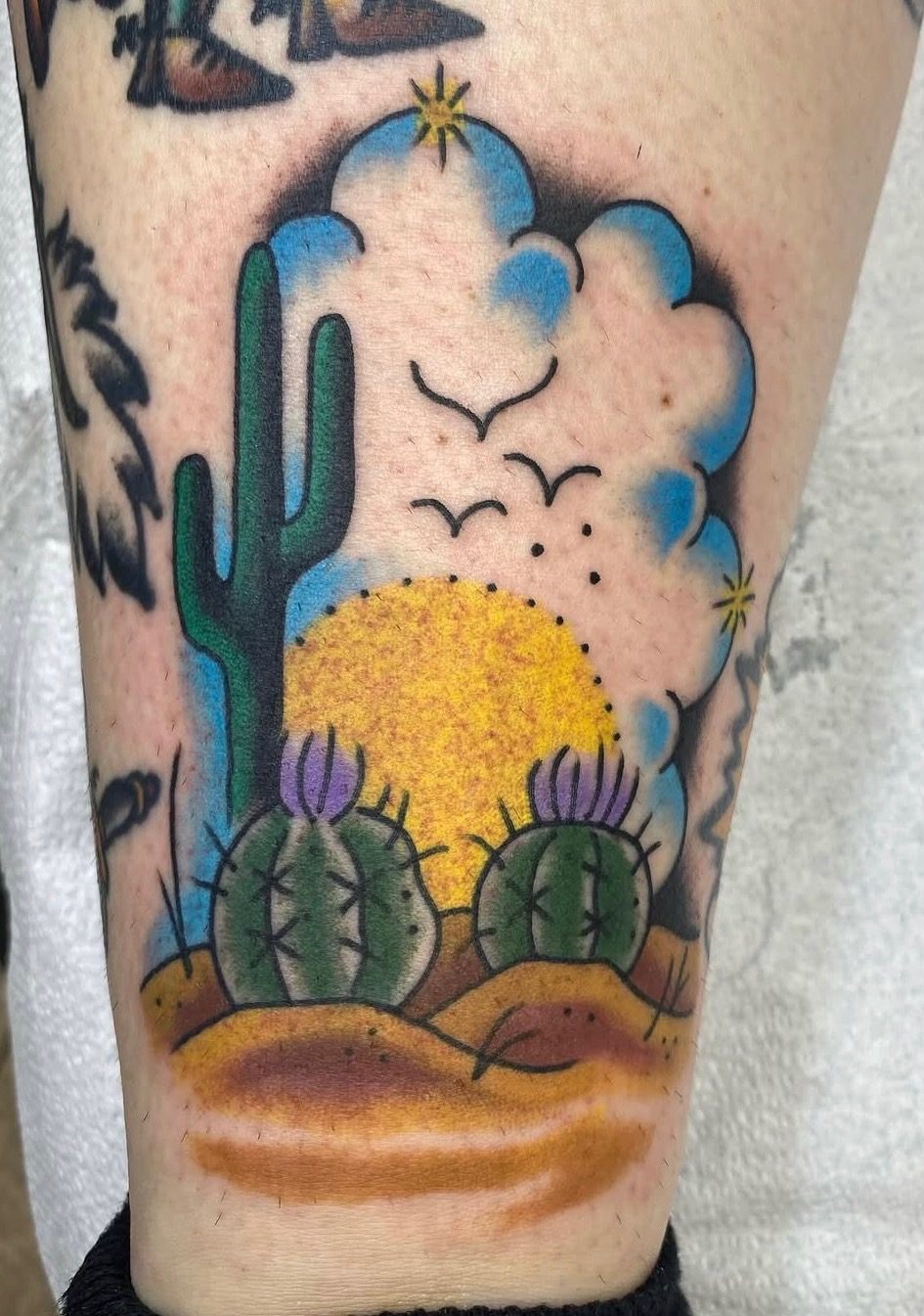 Illustrative desert cactus tattoo with clean outlines and compact color