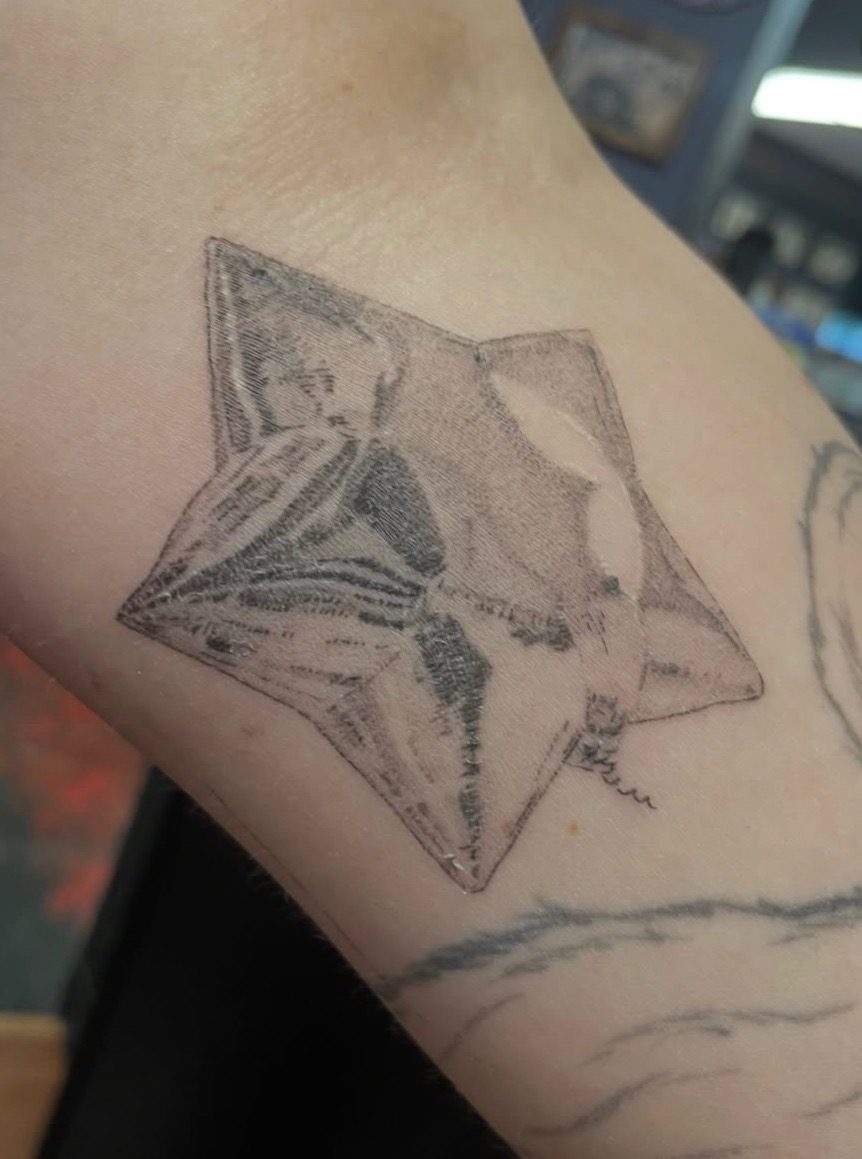 Fine line folded money star tattoo completed at Last Chance Tattoo in Las Vegas
